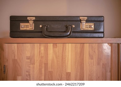 Briefcase with lock on the cupboard. - Powered by Shutterstock