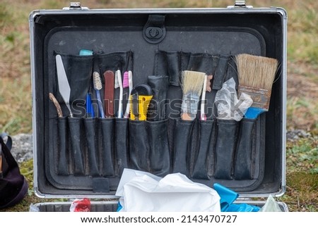 briefcase with small tools in an archaeological excavation Archaeology works