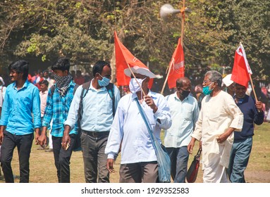 Brigade Parade Ground, Kolkata, 02-28-2021: Gathering Of Communist Party Of India Marxist (CPIM) Party Supporters During A Political Mega Rally, Carrying Large Party Flags On Shoulder.