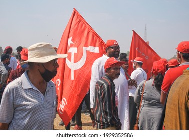 Brigade Parade Ground, Kolkata, 02-28-2021: Gathering Of Communist Party Of India Marxist (CPIM) Party Supporters During A Political Mega Rally, Carrying Large Party Flags On Shoulder.