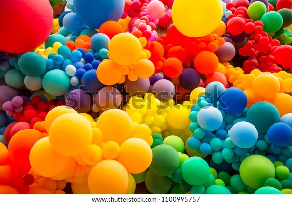 Bright abstract of jumble of rainbow colored balloons 