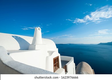 Bright abstract view of whitewashed Greek island architecture with calm blue Mediterranean Sea horizon in Santorini, Greece - Powered by Shutterstock