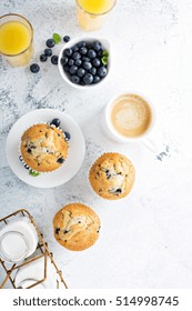 Bright And Airy Breakfast With Blueberry Muffin, Big Cup Of Coffee And Milk In Bottles Overhead View With Copyspace