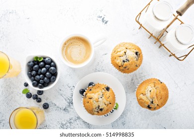 Bright And Airy Breakfast With Blueberry Muffin, Big Cup Of Coffee And Milk In Bottles Overhead View With Copyspace