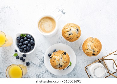 Bright And Airy Breakfast With Blueberry Muffin, Big Cup Of Coffee And Milk In Bottles Overhead View With Copyspace