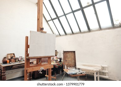 Bright Art Studio With A Large Window. Easels And Canvases, Workplace.