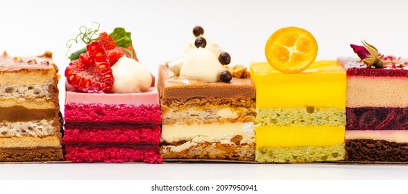 Bright assortment of several different pieces of biscuit fruit cakes on a white background - Shutterstock ID 2097950941