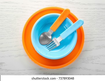 Bright Baby Tableware On Wooden Table