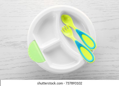 Bright Baby Tableware On Wooden Table