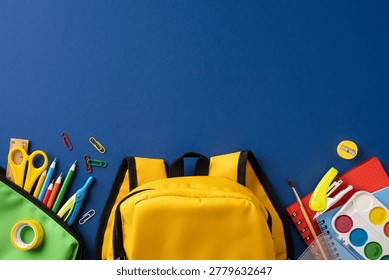 Bright back to school scene featuring a yellow backpack with assorted stationery including pencil, scissors, paint, notebook and colorful school supplies