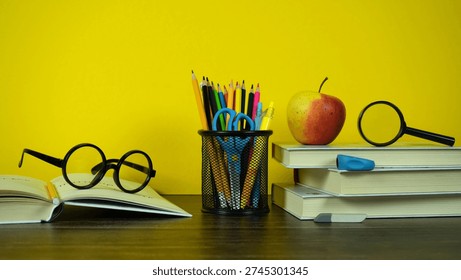 Bright Back to School Study Desk With Books, Pencils, Glasses, Apple and Magnifying Glass