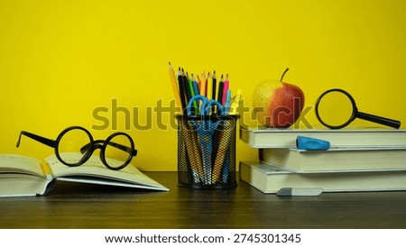 Bright Back to School Study Desk With Books, Pencils, Glasses, Apple and Magnifying Glass