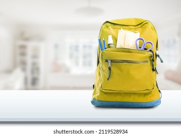 Bright Backpack On Table Home. School Supplies. Back To School Concept. Educational Design Objects.