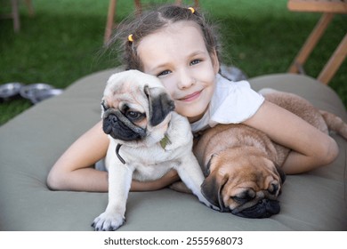 In a bright backyard setting, a joyful girl embraces two adorable puppies, showcasing affection while the sun shines down on their playful interaction. The scene radiates warmth and delight. - Powered by Shutterstock