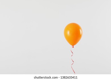 Bright balloon on light background, space for text. Celebration time