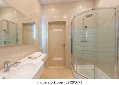 Bright bathroom interior with glass shower - Shutterstock ID 523290391