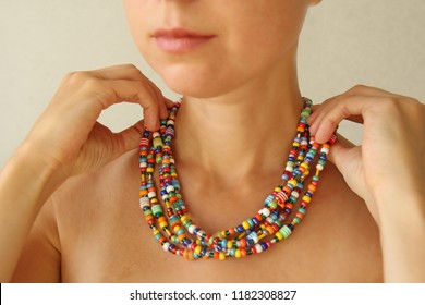 Bright Beads Of Murano Glass On A Young Girl. A Girl Dresses And Button Beads, Jewelry.