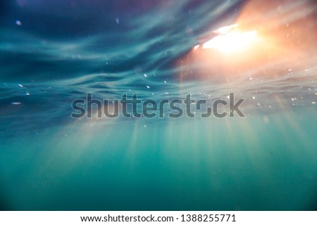 Bright beams of sunlight refracting through the surface of the atlantic ocean.