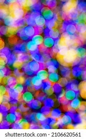 Bright beautiful multicolored bokeh background. Abstract background with flickering glitter lights with unfocused light. Template for postcards for holidays, Valentine's Day, party, Christmas, etc.
