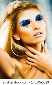 bright blond young woman with fashion style makeup posing sensual