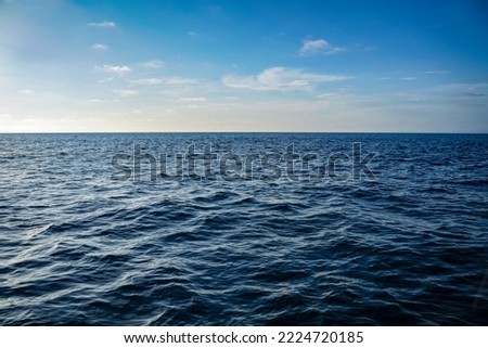 Bright blue Ocean water ripples background on a sunny day. Clean water consumption and natural resources