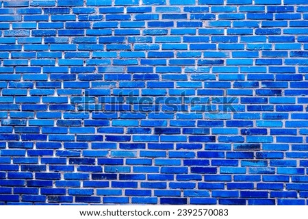 A bright blue painted brick wall, a background for cheerful masonry designs
