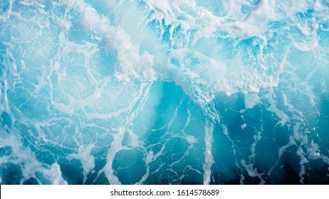 bright blue sea foam. marine background. light blue ocean wave. texture of sea foam. natural composition