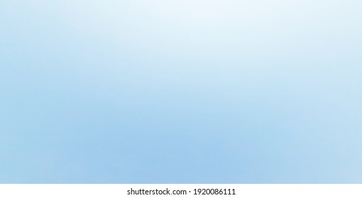 The bright blue sky is a cloudless sky, a clear sky, and the light shines gradient of the sky from dark to light.