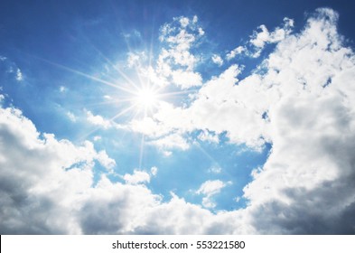 Bright Blue Sky With Clouds And Sun Rays