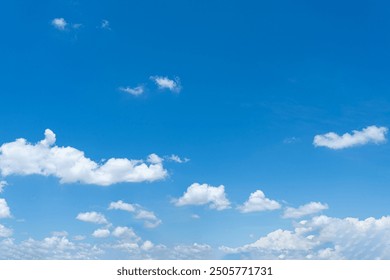 Bright blue sky with fluffy white clouds on a sunny day - Powered by Shutterstock