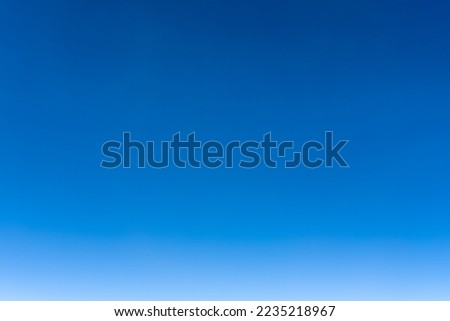 Bright blue sky gradient background. Clear empty sky texture, blank skyscape poster with no clouds. Cloudless empty sky. Natural background of the blue sky