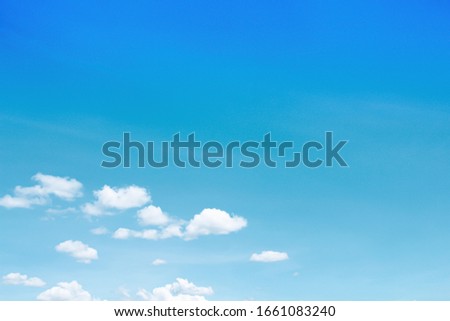 Bright blue sky with small clouds moving along the wind , summer day background and copy space
