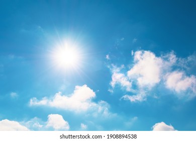 Bright blue sky and sun flare in spring sky with clouds vapor