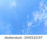 a bright blue sky with wispy white clouds, perfect for use as a background or texture in digital art or design projects.