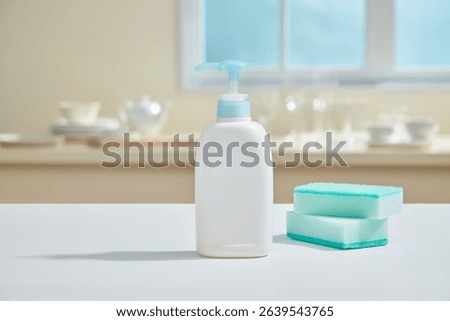 A bright blue sponge and pump bottle on a smooth kitchen surface with soft reflections and tidy surroundings evoking cleanliness.