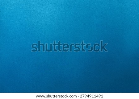 A bright blue surface with a smooth and even texture. It can be used for design projects or as a backdrop for various creative activities.