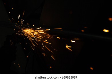Bright blue and yellow sparks on a black background. Magical lig