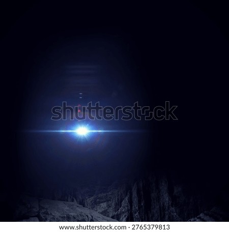 Bright blue-white light source is illuminating rugged rocky canyon at night in 3D render. Aurora, light burst, abstract, celestial, cosmic, dramatic, landscape