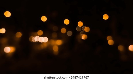 Bright blurry golden bokeh lights on dark background, abstract pattern, exterior decoration with lights for party, Christmas or New Year, festival. - Powered by Shutterstock