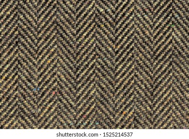 Bright Brown Woolen Fabric Striped Zigzag. Herringbone Tweed, Cashmere Background Texture. Coat Close-up. Expensive Men's Suit Fabric. High Resolution