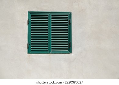 Bright Cement Wall, Window With Green Closed Shutters, No Person, Space For Text On Background