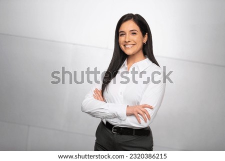 A bright and cheerful finance business woman, hispanic executive, boss, CEO, entrepreneur, student, smiling and standing confidently with arms crossed	 ストックフォト © 