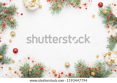 Bright Christmas frame of spruce, red & gold christmas decorations on white background. Copy space. Winter holidays, New Year.