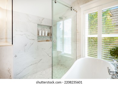 Bright And Clean White Bathroom With Subway Tile Glass Shower And Claw Footed Bathtub