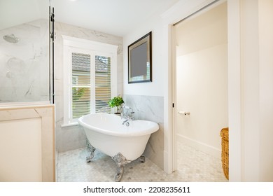 Bright And Clean White Bathroom With Subway Tile Glass Shower And Claw Footed Bathtub