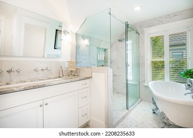 Bright And Clean White Bathroom With Subway Tile Glass Shower And Claw Footed Bathtub