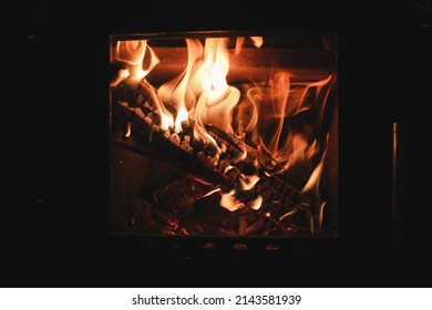 Bright Colored Dancing Flames In Fireplace. Close Up Of Burning Firewood. Cozy Warm Background