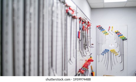 Bright colored special hooks using in PDR work process to remove dents on a stand - Shutterstock ID 1959974488