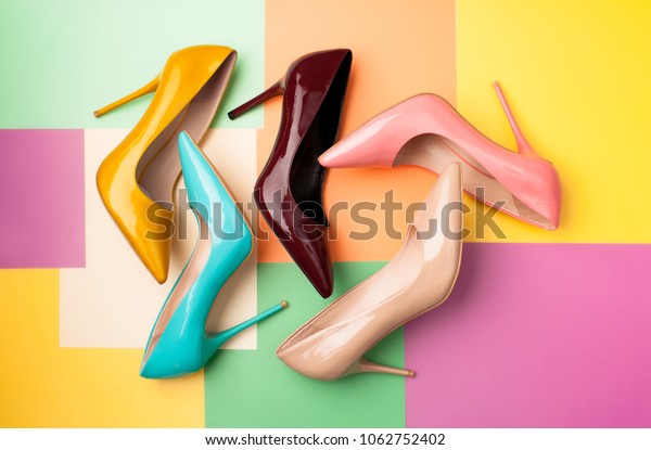 Bright colored women\'s shoes on a solid background.\
Copy space text.