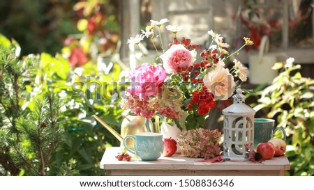 Similar – Woman decorated large bouquet of flowers with roses in vase